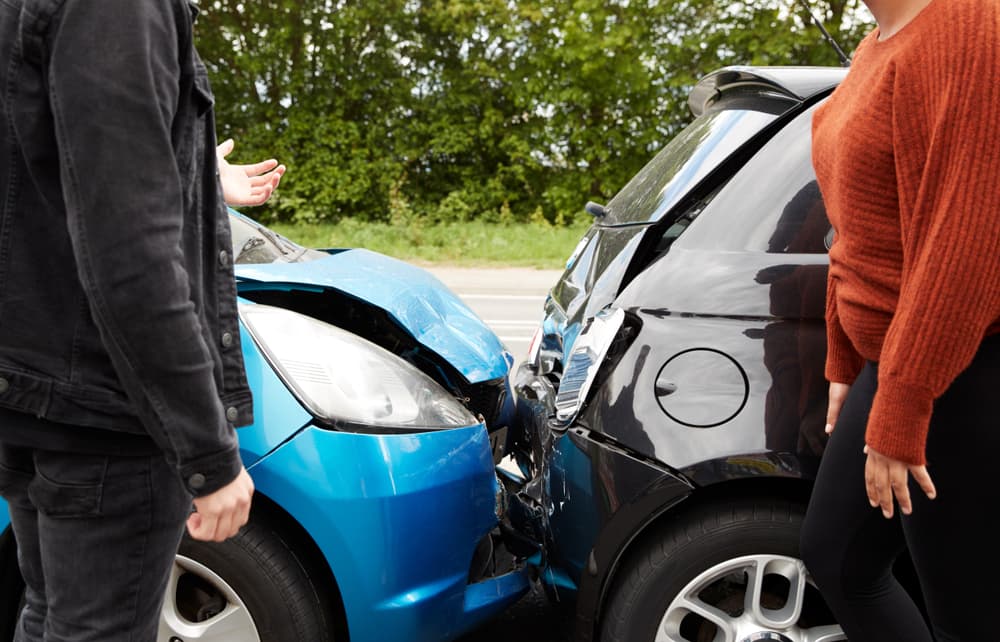 Two enraged motorists engage in a heated argument over the allocation of responsibility for a car accident.