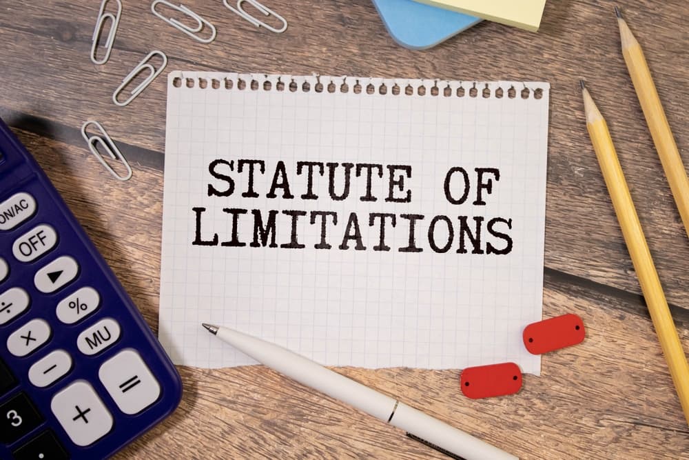 The concept of law and justice is depicted with a notebook inscribed "STATUTE OF LIMITATIONS" set against the background of the South African flag.






