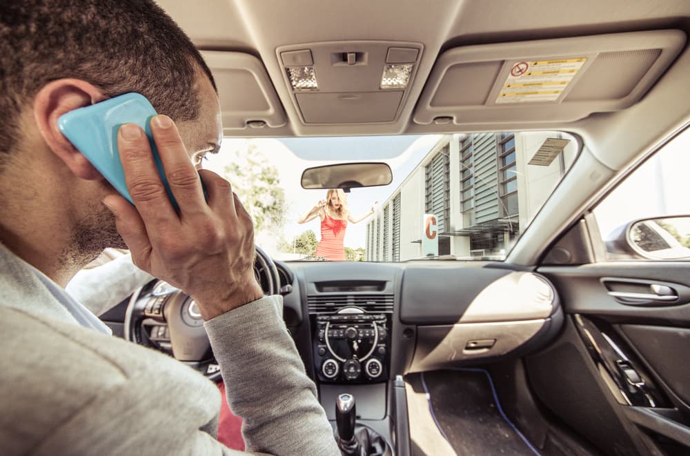 Car accident: Distracted driver on the phone runs over a pedestrian. A stark reminder of the dangers of texting and driving.