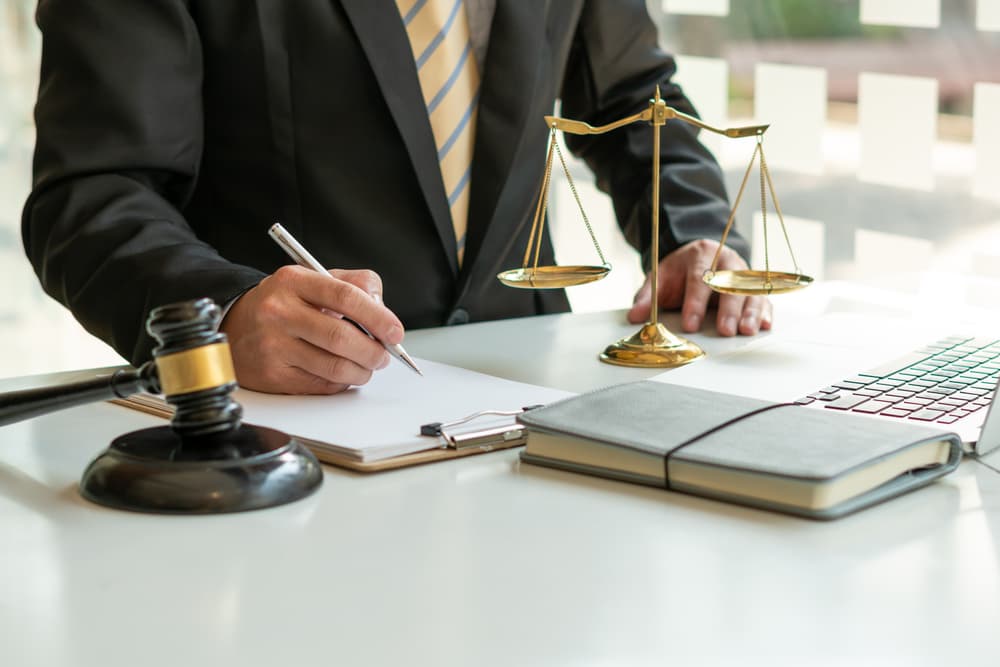 Attorneys or judges signing important documents, representing the legal concepts of the judiciary and the legislature.