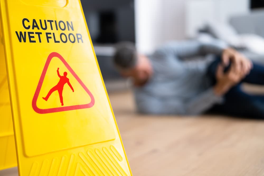 Slip and fall accident. Floor sign indicating caution and safety.






