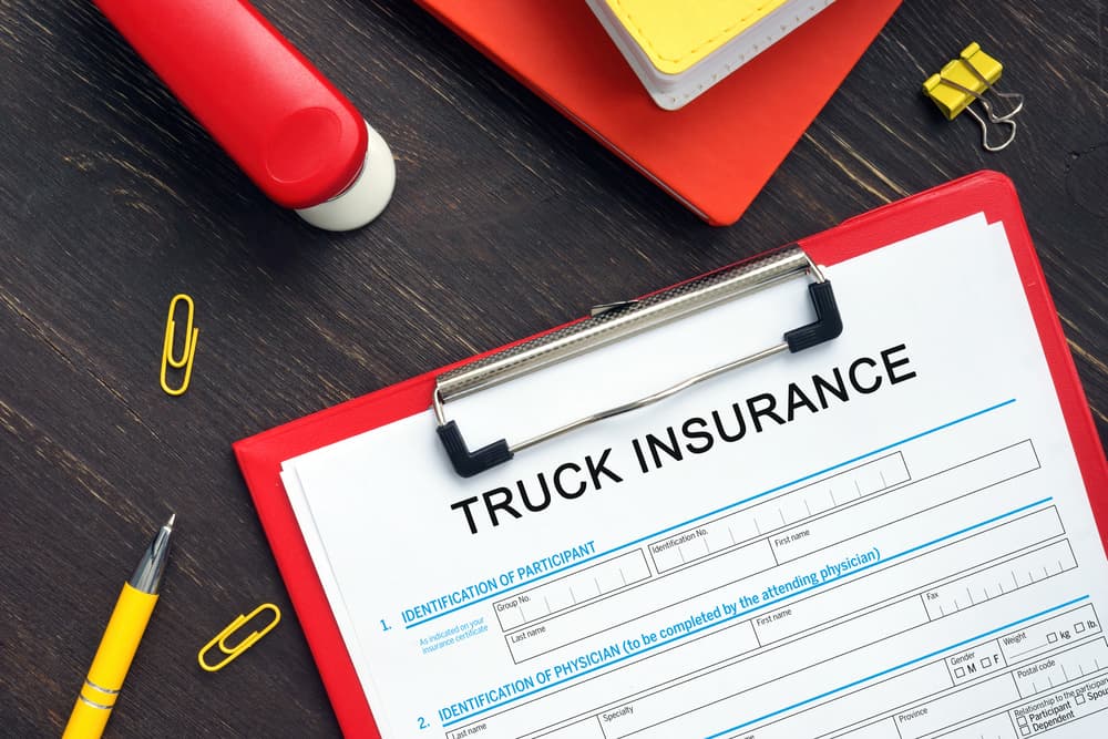 Financial concept of TRUCK INSURANCE Application Form with the phrase on a business paper.






