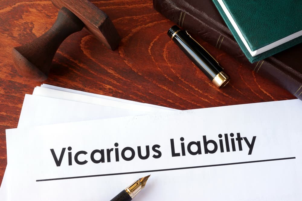 Papers titled "Vicarious Liability" on a table.