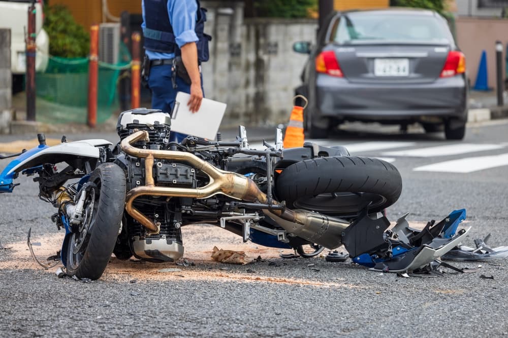 A motorcycle collided with a passenger car at an intersection.