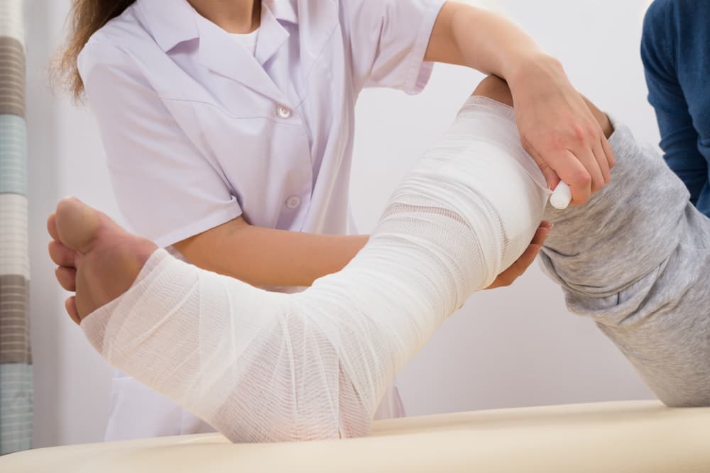 A Female Doctor Bandaging a Patient's Leg after a truck accident.






