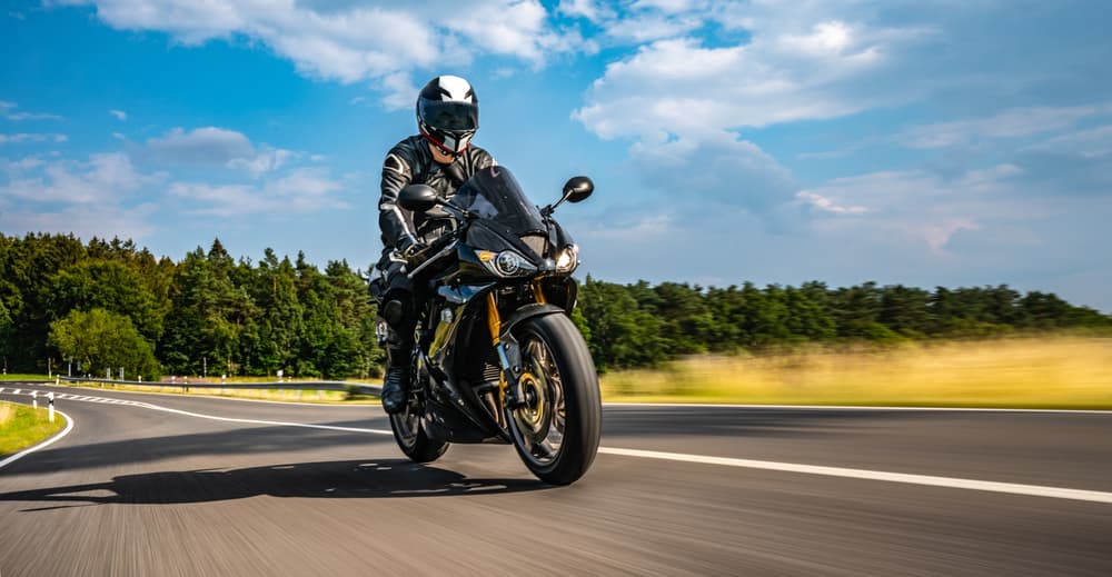 Motorbike on the road, riding and having fun on an empty road during a motorcycle tour journey.