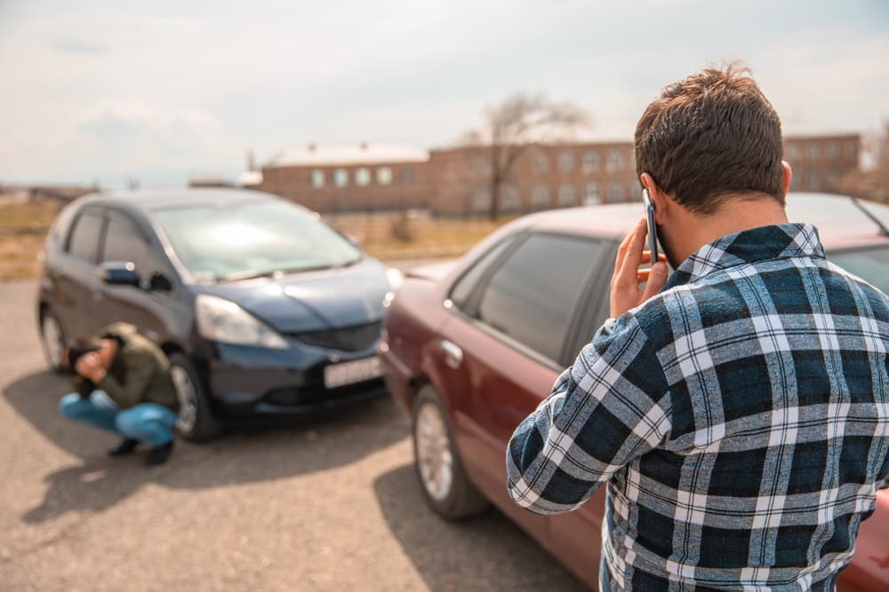 Photo of a driver calling the police after a car accident.