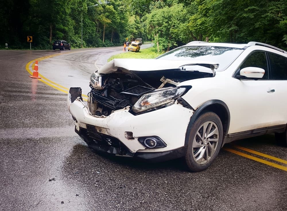 A white car had an accident on a curved road